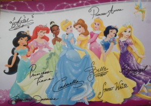 There are eight princesses on the front of the postcard, as well as Tinkerbell.